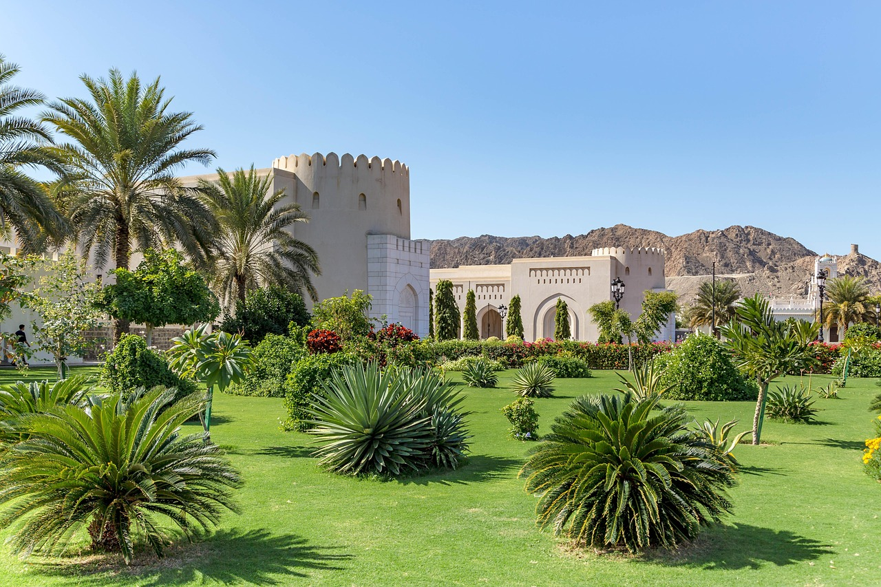 Omani palace gardens with mountains beyond